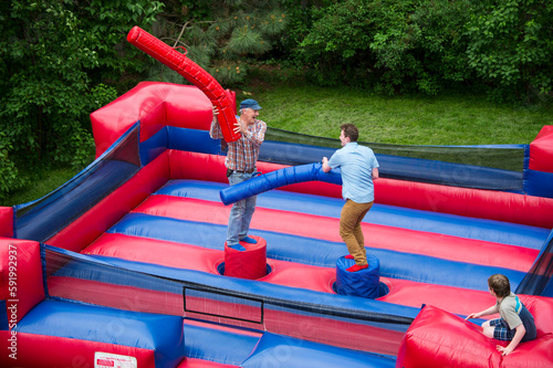 Two men battle in an inflatable jousting ring; Lincoln, Nebraska, United States of America