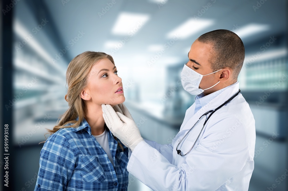 Portrait of doctor with a patient In medical Exam Room.