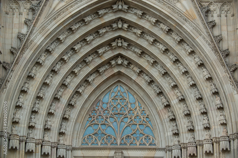 Architectural detail of the arch work and tracery above the main entrance of the Catedral de Barcelona; Barcelona, Spain Architectural detail of the arch work and tracery above the main entrance of the Catedral de Barcelona; Barcelona, Spain