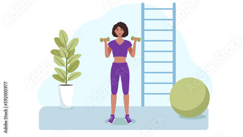 The girl is engaged in sports with dumbbells in her hands. The concept of a healthy lifestyle, exercises with dumbbells.