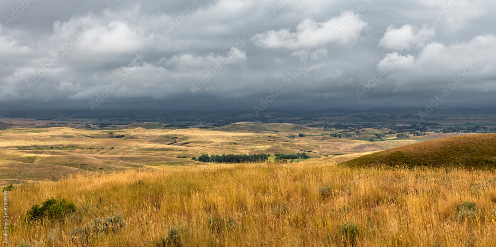 View of the rolling hills and threatening weather from the Bozeman Trail Head off I-90 near Sheridan, Wyoming, USA; Wyoming, United States of America View of the rolling hills and threatening weather from the Bozeman Trail Head off I-90 near Sheridan, Wyoming, USA; Wyoming, United States of America