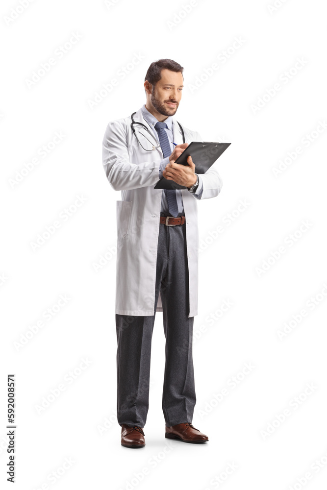 Full length shot of a male doctor standing and writing a document Full length shot of a male doctor standing and writing a document
