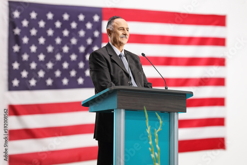 USA politician giving a speech on a podium and smiling photo