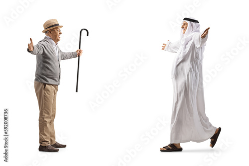 Senior man meeting an arab man in traditional muslim clothes