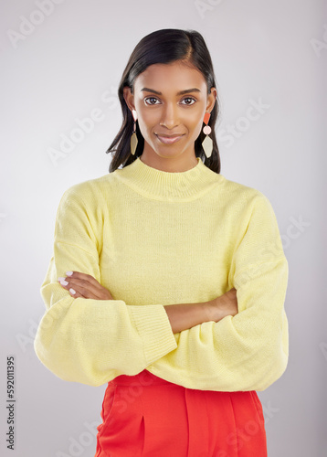 Confident, corporate and portrait of woman arms crossed feeling proud isolated in a studio white background. Confidence, assertive and young Indian female worker, leader or employee with calm mindset photo