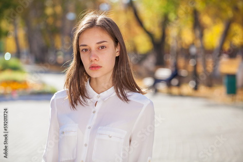 Portrait of a young beautiful model in white shirt