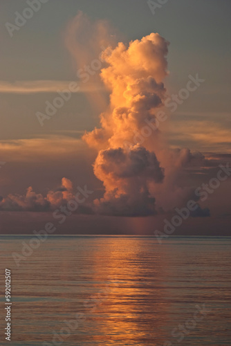 Tall vertical cloud at sunset over the ocean; Seychelles