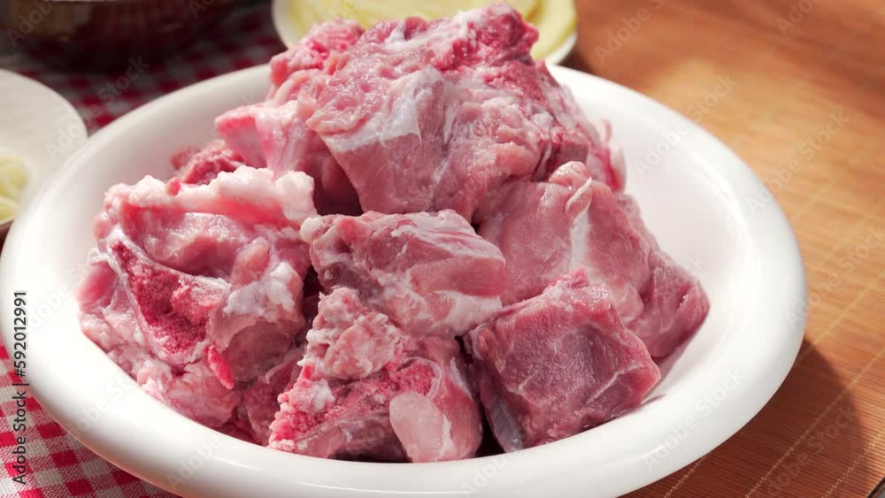 Fresh pork spine in a white porcelain plate