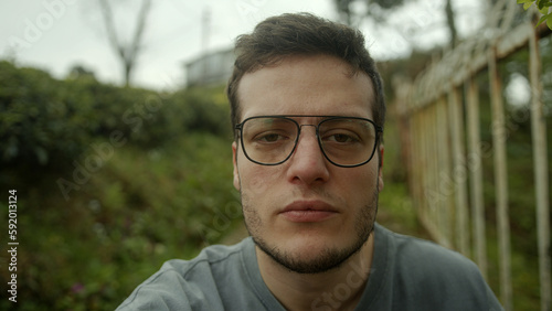 A Young Handsome Brown-Haired Man Engaged in a Video Conference, Looking Directly at the Camera and Listening Attentively - POV Shot