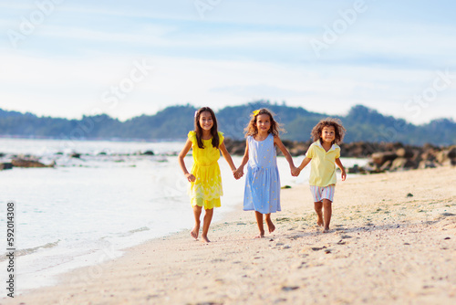 Group of kids playing on tropical beach.