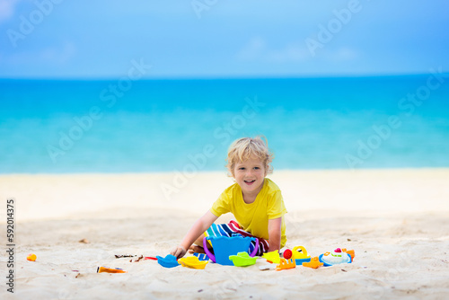 Kids playing on beach. Children play at sea. © famveldman