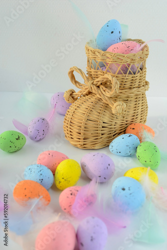 straw wicker shoe with colorful Easter eggs. Easter
