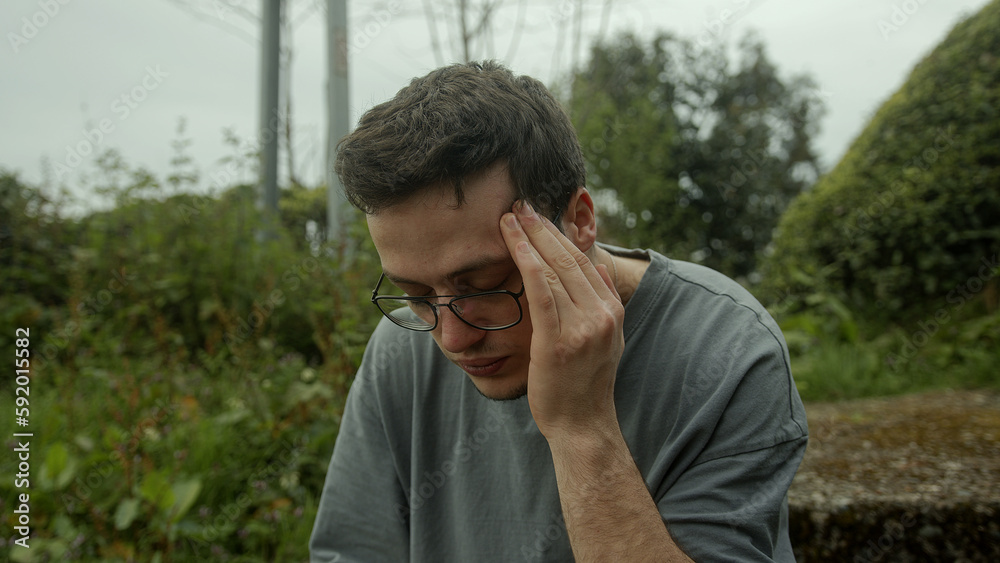 Man with glasses writhes in pain, battling a sudden onset of health problems Man with glasses writhes in pain, battling a sudden onset of health problems