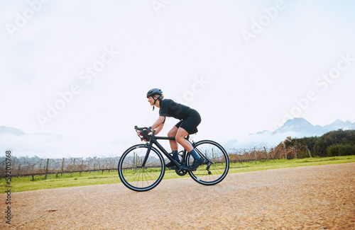 Cycling, training and fitness with woman in nature and mockup for race, workout and challenge. Exercise, workout and travel with female cyclist riding on bike for journey, adventure and cardio