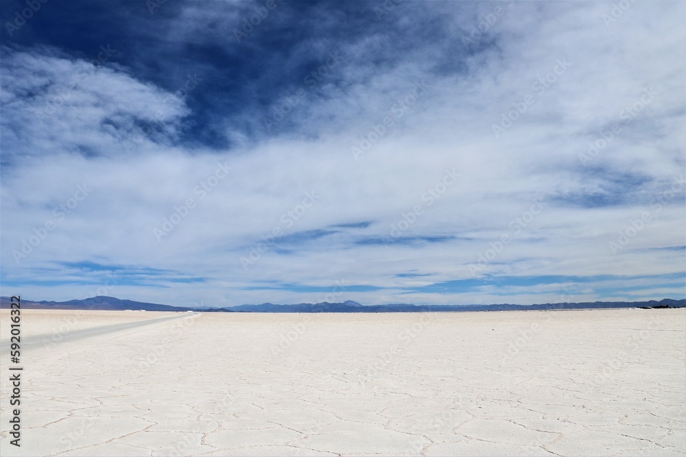 the salt flats of Salinas Grandes in Argentina with cloudy blue sky