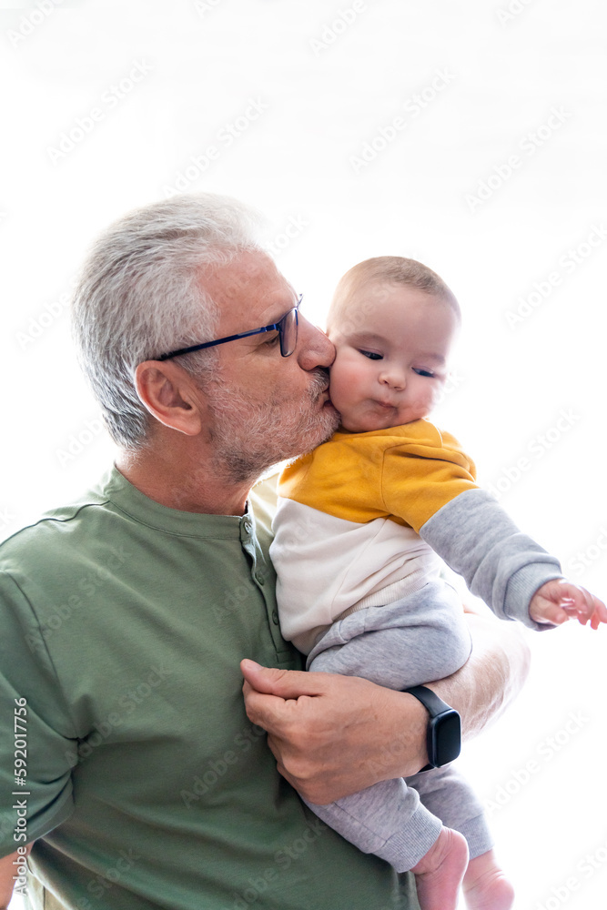 Grandfather giving a kiss to his baby grandson Grandfather giving a kiss to his baby grandson