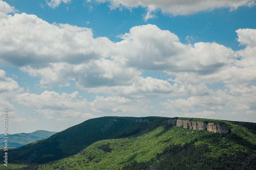 Naklejka premium blue sky beautiful nature green forest mountains hiking journey