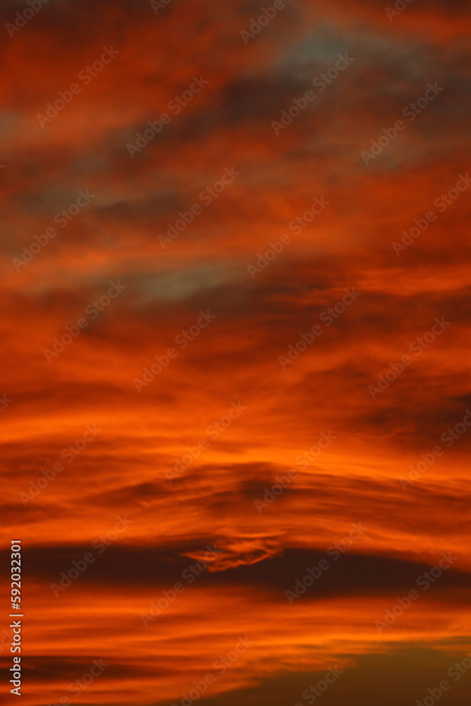 Blurry background of red   sunset sky. Dramatic sky with colorful cloud background. Red burning sunset sky.  Copy space.
