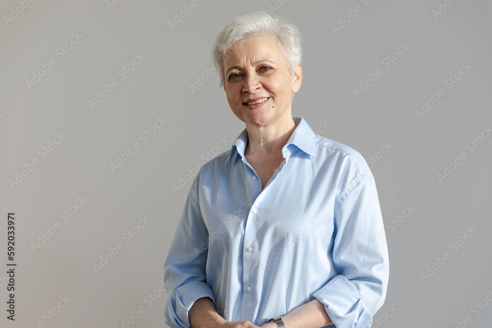 Confident stylish european middle aged senior woman. Older mature 60s lady smiling in white background. Happy attractive senior female looking camera close up face headshot portrait. Happy people Confident stylish european middle aged senior woman. Older mature 60s lady smiling in white background. Happy attractive senior female looking camera close up face headshot portrait. Happy people