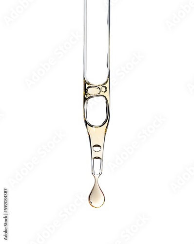 Cosmetic serum pipette with a yellow drop oil or aha asids close up on white isolated background photo