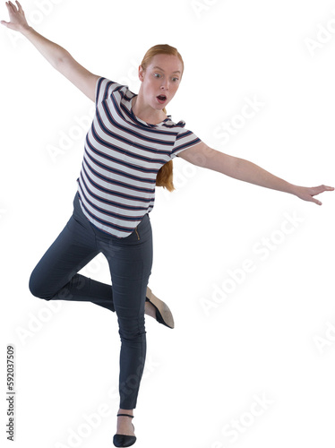 Woman balancing while walking against white background