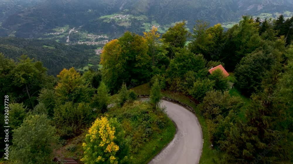 OVARO MIONE, ITALY - APRIL, 2023: Aerial drone view of a valley in the morning with clouds. Small mauntain village Mione with beautiful houses on the green slopes of the Italian Alps. OVARO MIONE, ITALY - APRIL, 2023: Aerial drone view of a valley in the morning with clouds. Small mauntain village Mione with beautiful houses on the green slopes of the Italian Alps.