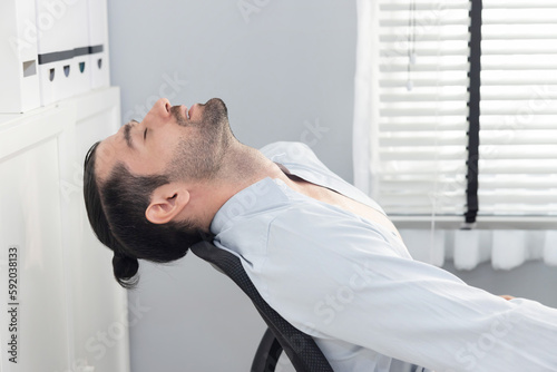 Cuadro en lienzo Caucasian Businesman Leaning Back in Chair While Masturbating at Work