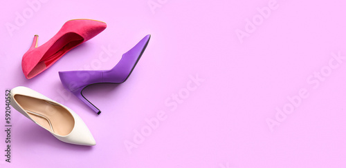 Fashionable high heeled shoes on lilac background with space for text