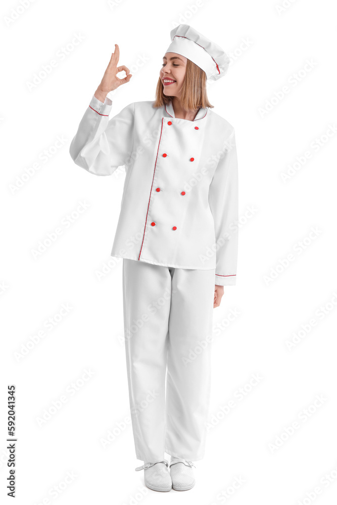 Female baker in uniform showing OK on white background Female baker in uniform showing OK on white background