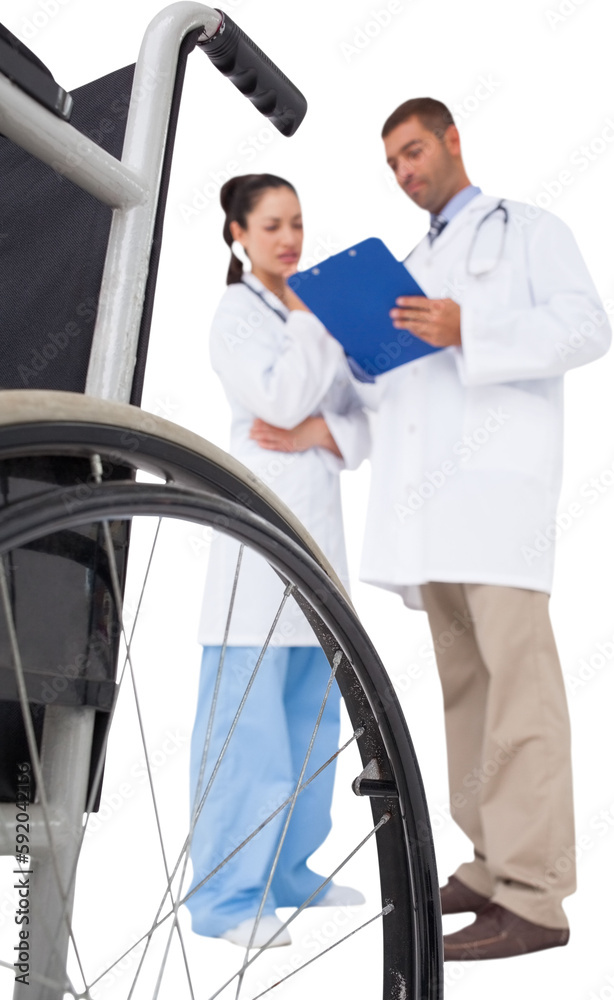 Doctors discussing something on clipboard Doctors discussing something on clipboard
