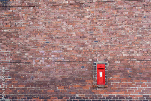 British King George V Red Post Box Mounted in a Brick Wall photo