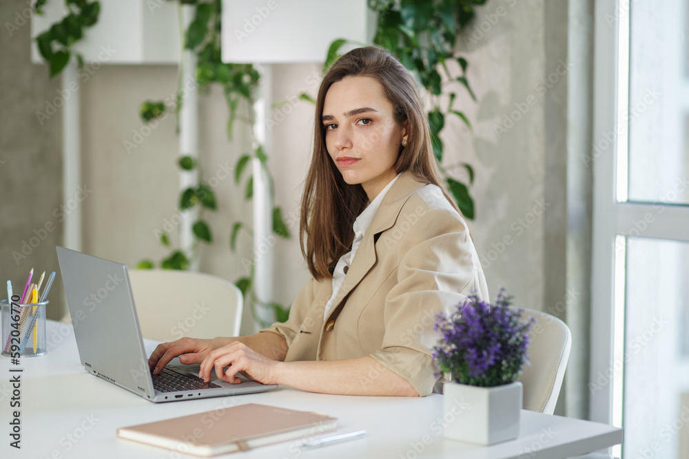 Woman is working job on laptop computer in modern office. Concept of work, study and it. Woman is working job on laptop computer in modern office. Concept of work, study and it.
