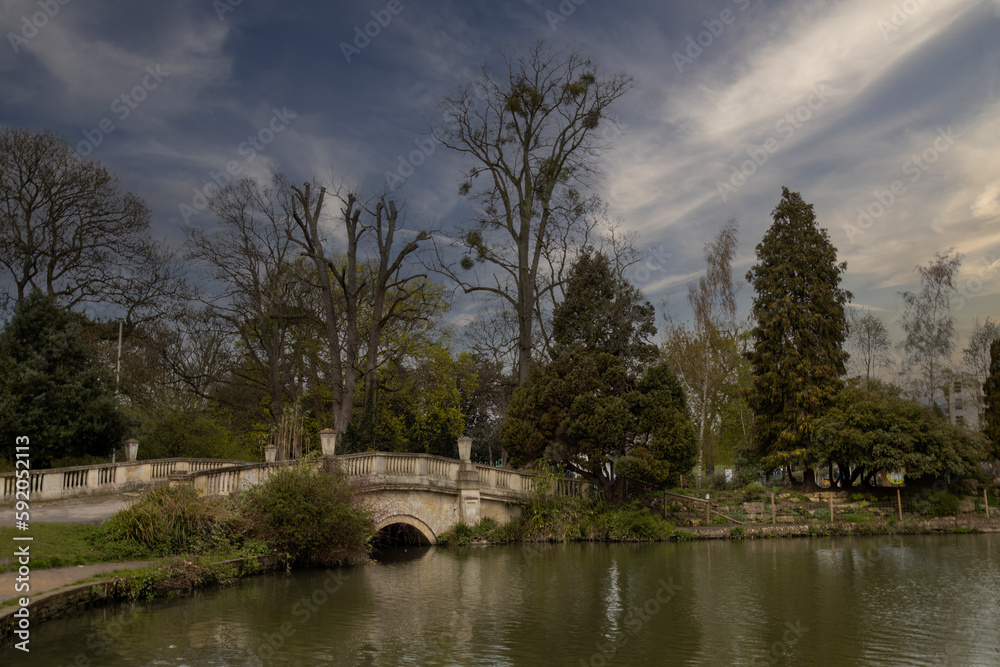 A small stone bridge in Pitville Park in Cheltenham, Gloucestershire, UK