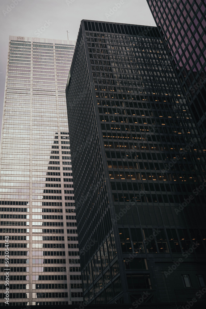 Business and finance concept, moody photography view looking at modern office building architecture in the Toronto financial district, Ontario, Canada.