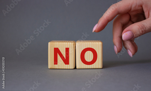 No symbol. Concept words No on wooden blocks. Businessman hand. Beautiful grey background. Business and No concept. Copy space.