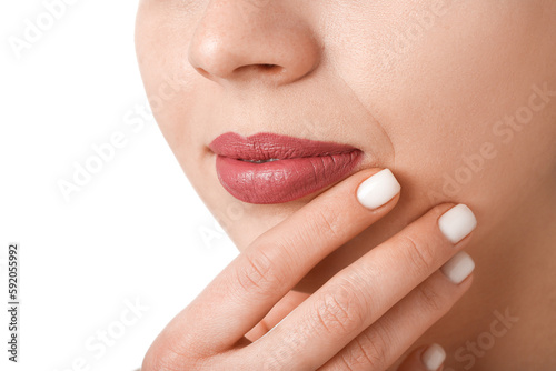 Woman with pink lips on white background, closeup