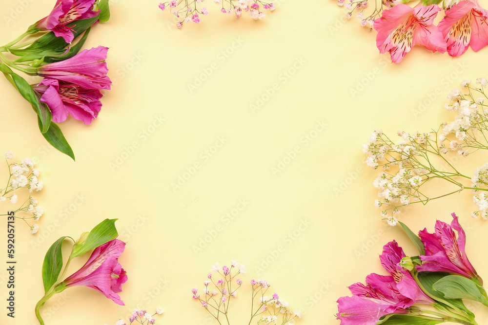 Frame made of alstroemeria and gypsophila flowers on yellow background