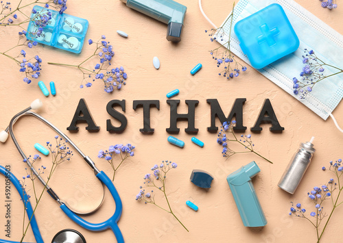 Word ASTHMA with inhalers, pills, stethoscope and flowers on beige background