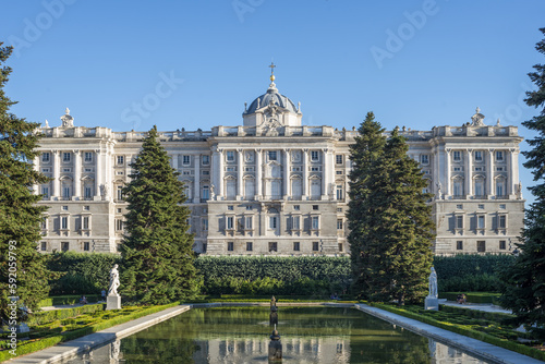 View of one of the side facades of the Royal Palace of Madrid with some gardens in the foreground