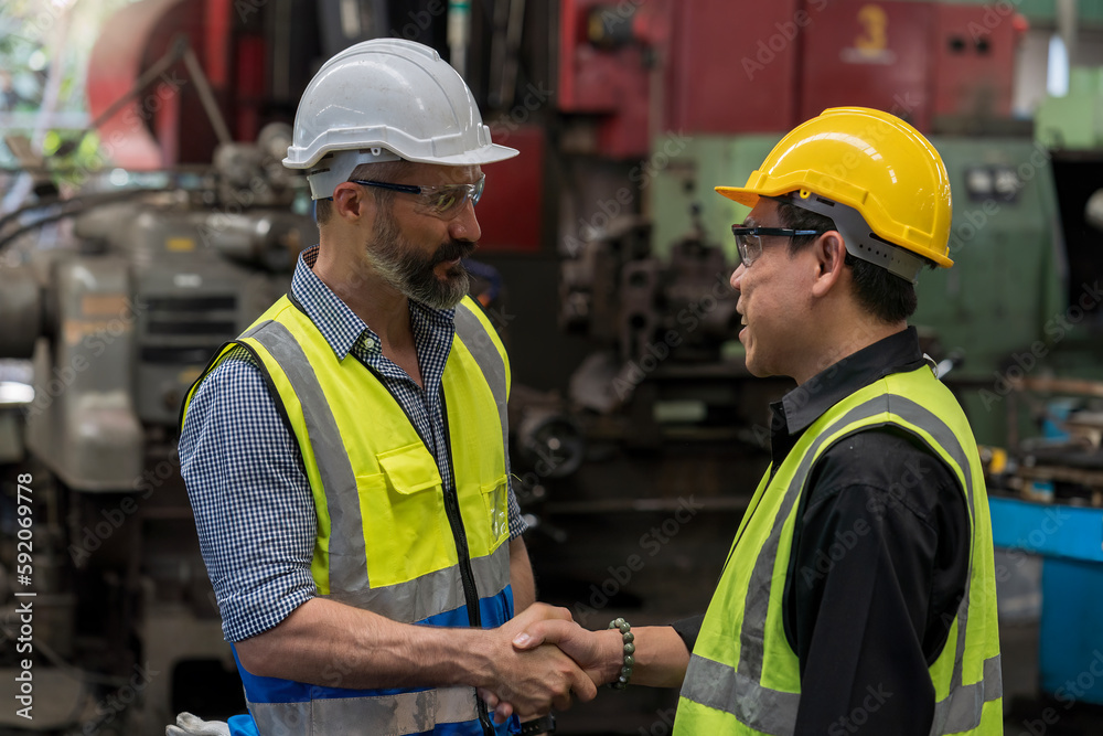 Engineer people Happy to be successful partnership team. Smiling Engineer shaking hands. Metal Machine. Engineer people Happy to be successful partnership team. Smiling Engineer shaking hands. Metal Machine.