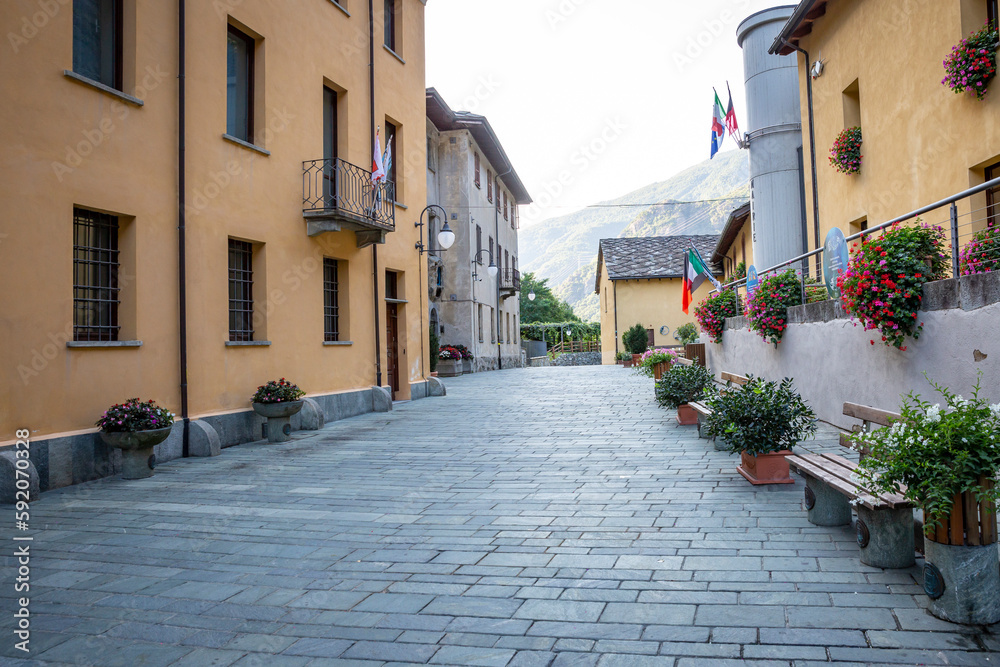 a street in Bard village decorated with flower pots, Aosta Valley, Italy