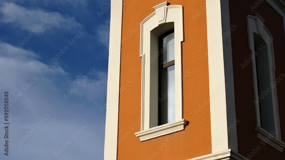 elongated window in brick facade against the sky
