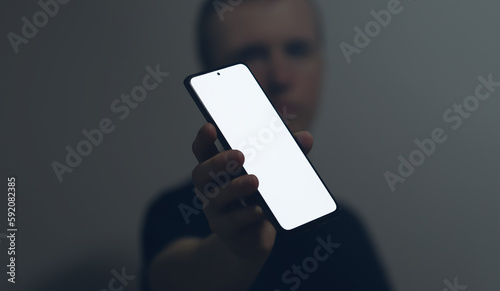 Photo of a man with a mobile phone in his hand
