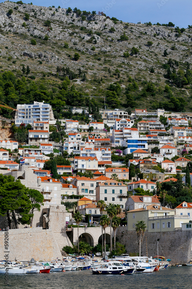 View of modern buildings and villas on the sea coast, on mountain background in Dubrovnik, Croatia.