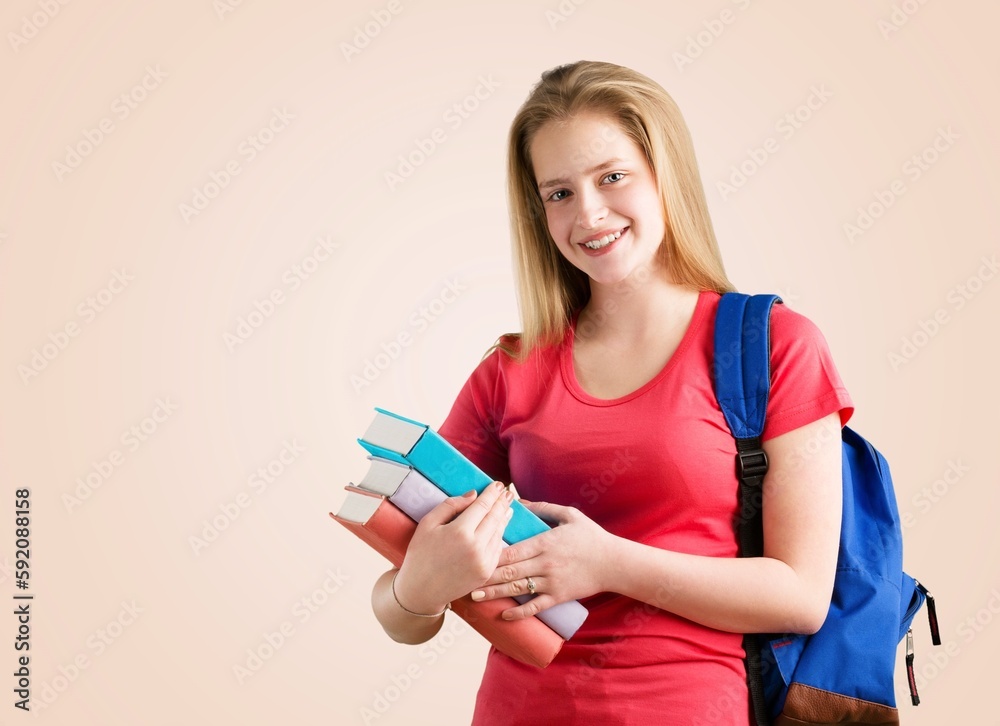 Thoughtful young woman student standing with books Thoughtful young woman student standing with books