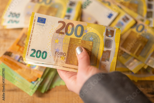  Recalculation of money.200 euro banknotes.Hands recalculate banknotes.Expenses and incomes in European countries.pack of money in a hand close -up. photo