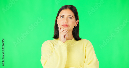 Mind, thinking and decision with a woman on a green screen background in studio to consider an option. Idea, face and contemplating with an attractive young female looking thoughtful on chromakey