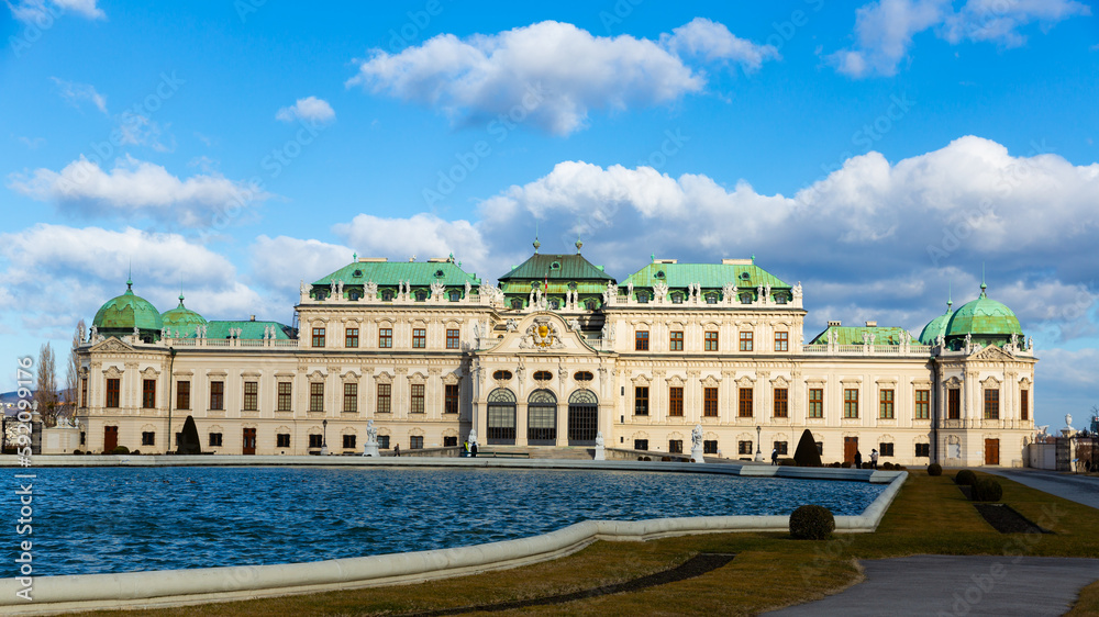 Majestic baroque architecture of Belvedere palace near great water basin in upper parterre of historic building complex in Vienna on sunny winter day, Austria