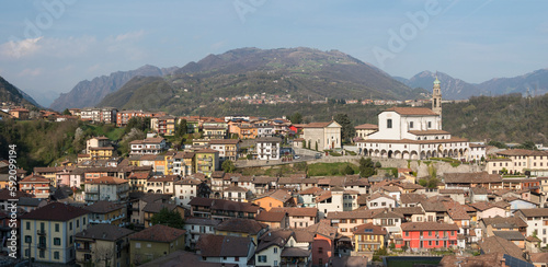 Overview of the town of Vertova (Province of Bergamo, Lombardy, Italy) with the parish church of Santa Maria Assunta rebuilt in the 18th century to a design by Giovanni Battista Quadri. April 2023.