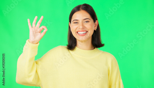 Ok, green screen and portrait of woman doing a perfect sign or hand gesture isolated in a studio background. Excited, happy and female showing approval, accept and agreement signal for perfection